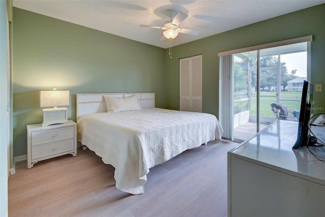 bedroom featuring light wood-type flooring, a closet, access to exterior, and ceiling fan