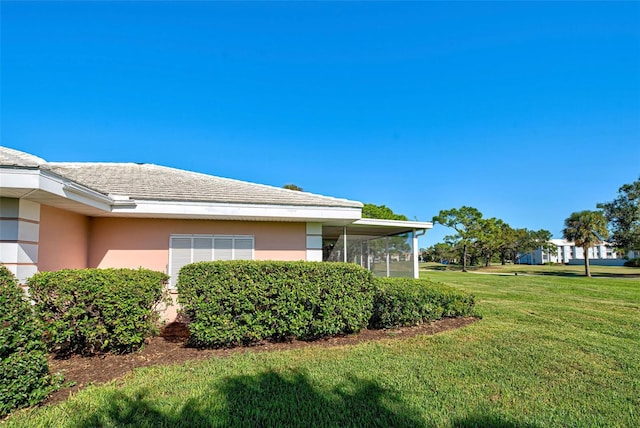 view of side of home featuring a lawn