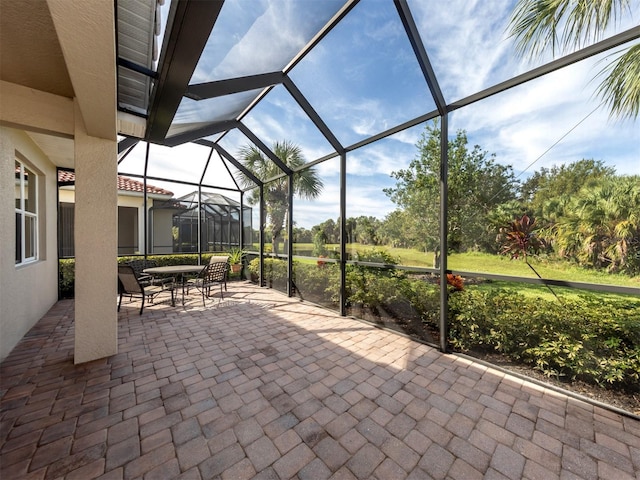 view of patio featuring a lanai