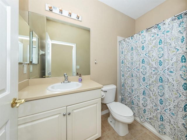 bathroom featuring toilet, tile patterned flooring, and vanity