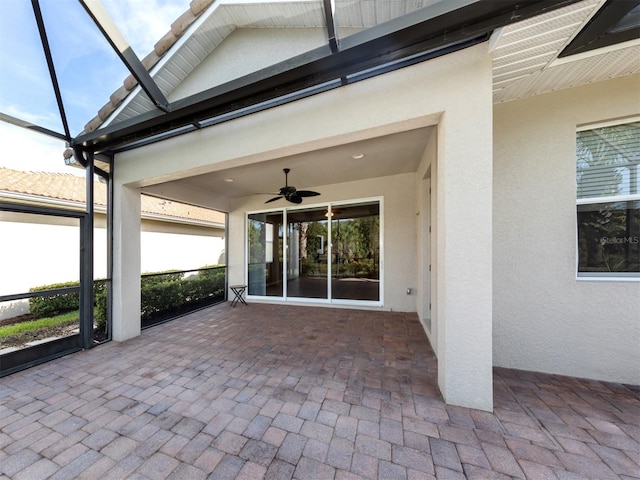 view of patio / terrace with ceiling fan and glass enclosure