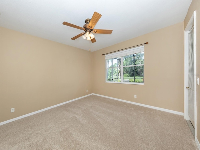 carpeted empty room featuring ceiling fan