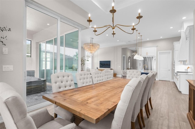 dining space with light wood-type flooring and a notable chandelier