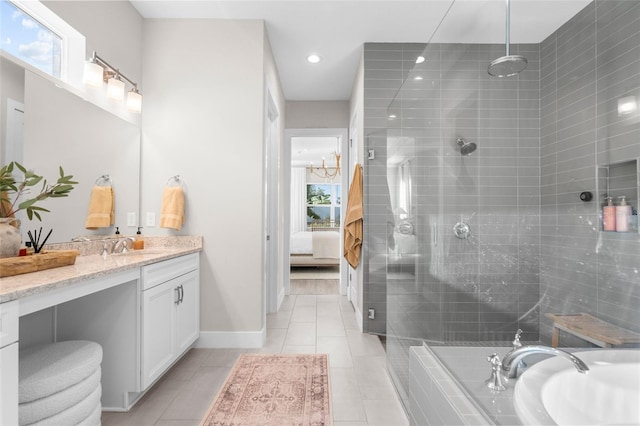 bathroom featuring tile patterned floors, vanity, separate shower and tub, and a chandelier