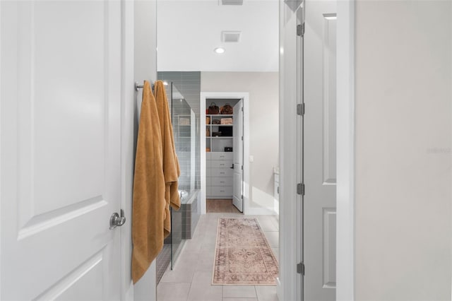 bathroom with tile patterned flooring and walk in shower