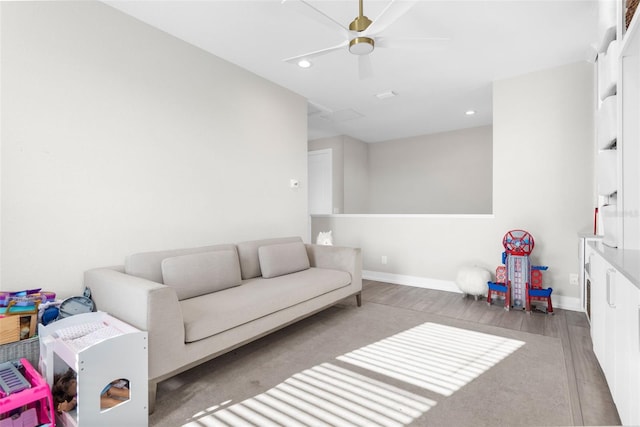 living room with hardwood / wood-style flooring and ceiling fan