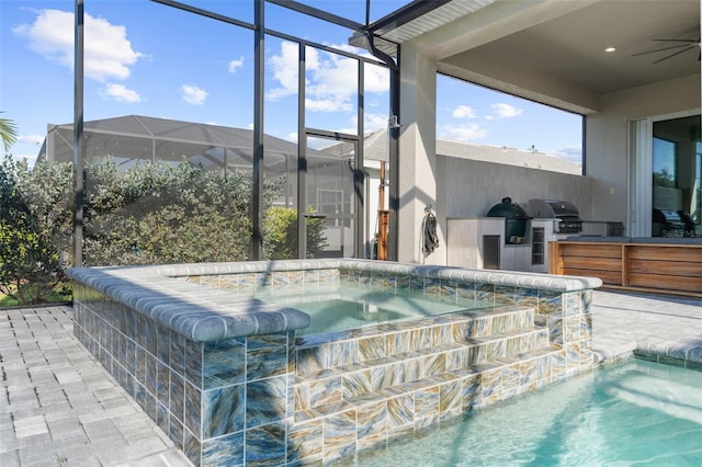 view of pool featuring area for grilling, a patio area, pool water feature, and ceiling fan