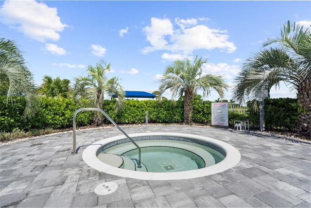 view of pool with a hot tub