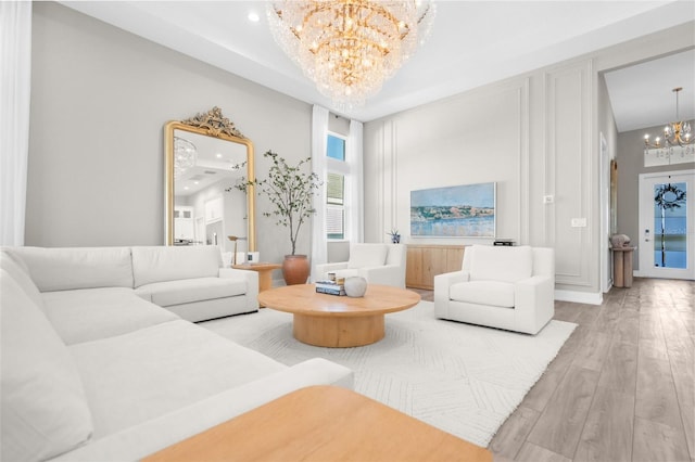 living room featuring hardwood / wood-style flooring and an inviting chandelier