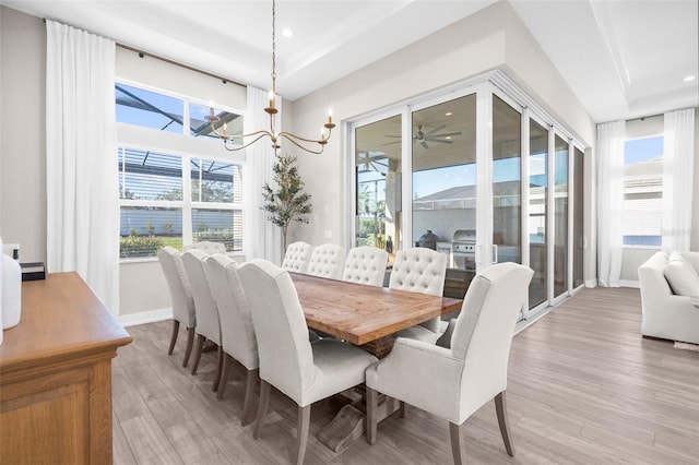 dining room with a chandelier, plenty of natural light, and light hardwood / wood-style floors