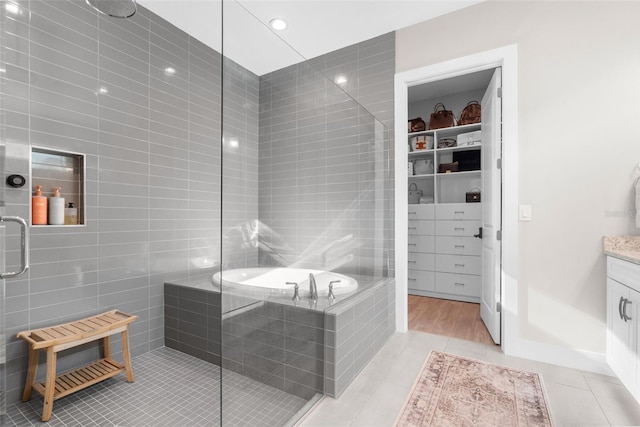 bathroom with tile patterned flooring, vanity, and independent shower and bath