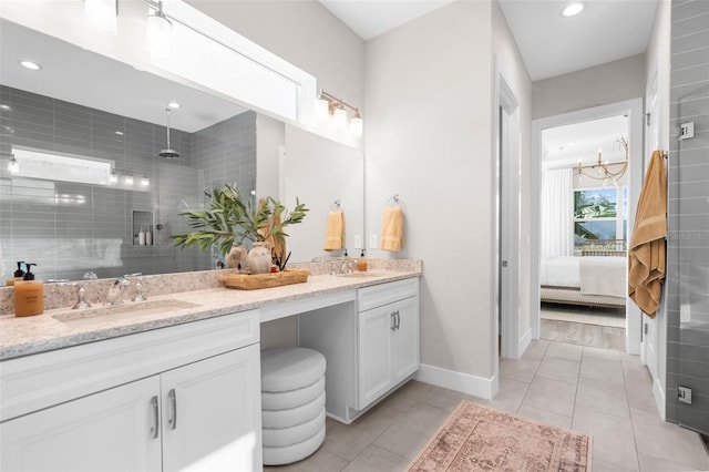 bathroom featuring tile patterned flooring, vanity, a chandelier, and an enclosed shower