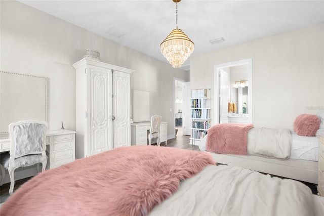 bedroom with dark hardwood / wood-style floors and a chandelier