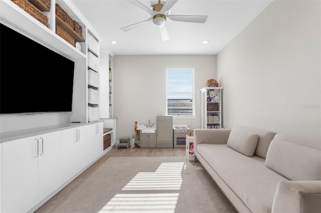 living room with ceiling fan and light hardwood / wood-style floors