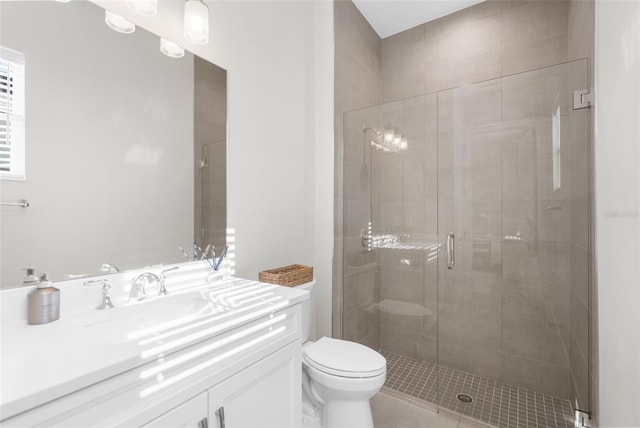 bathroom with tile patterned floors, vanity, toilet, and a shower with shower door