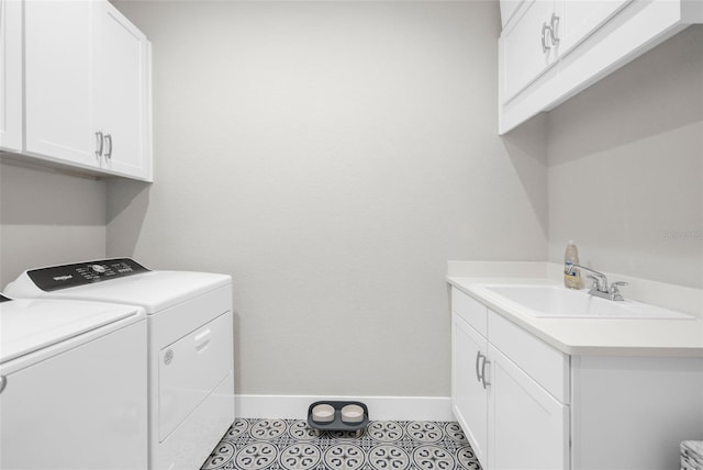 washroom featuring washer and clothes dryer, sink, light tile patterned flooring, and cabinets