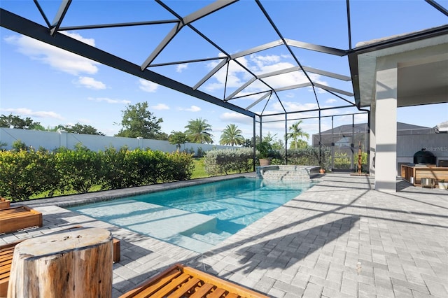 view of swimming pool with a jacuzzi, a patio area, and a lanai