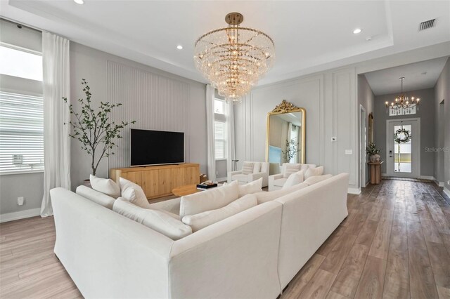 8209 Redonda Loop, Lakewood Ranch, FL 34202 - living room featuring visible vents, light wood finished floors, baseboards, recessed lighting, and an inviting chandelier
