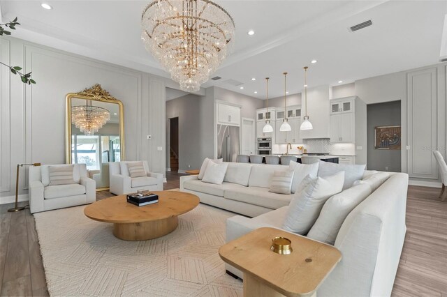8209 Redonda Loop, Lakewood Ranch, FL 34202 - living room with visible vents, light wood-style floors, recessed lighting, and a chandelier