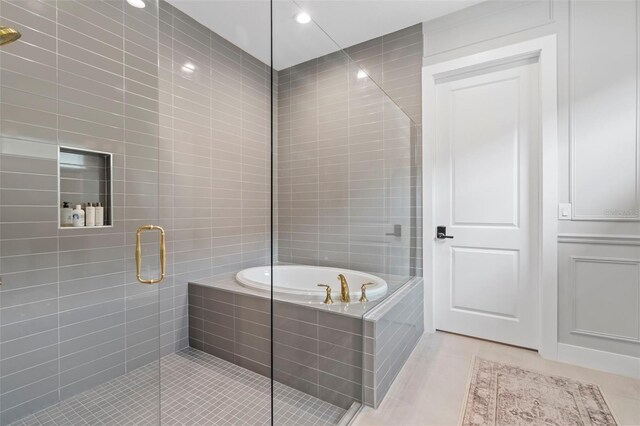 8209 Redonda Loop, Lakewood Ranch, FL 34202 - full bath featuring a bath, a stall shower, and tile patterned flooring