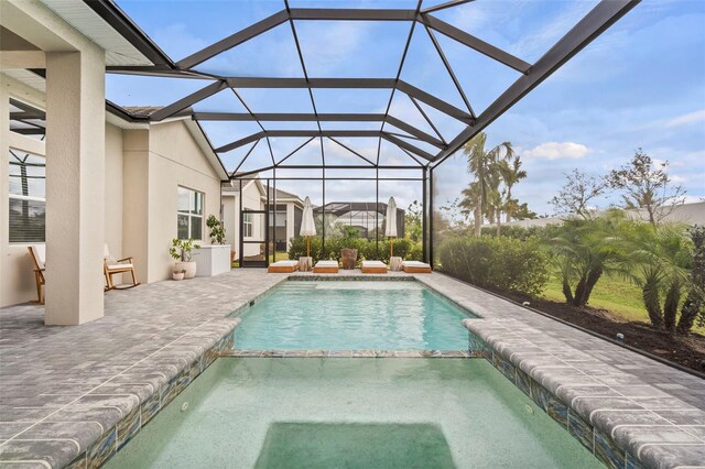 8209 Redonda Loop, Lakewood Ranch, FL 34202 - view of swimming pool with a pool with connected hot tub, glass enclosure, and a patio area