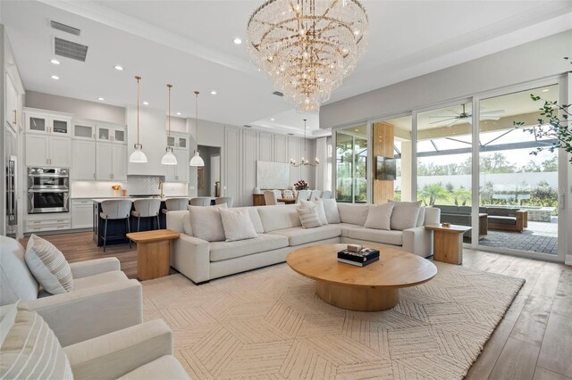 8209 Redonda Loop, Lakewood Ranch, FL 34202 - living room with visible vents, a sunroom, light wood-style floors, and recessed lighting