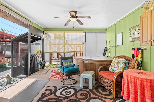 sunroom / solarium featuring plenty of natural light and ceiling fan