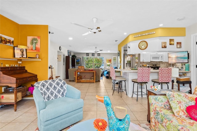 living room featuring ceiling fan and light tile patterned floors