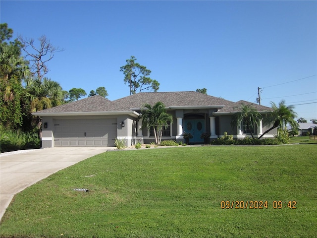 ranch-style house featuring a garage and a front lawn