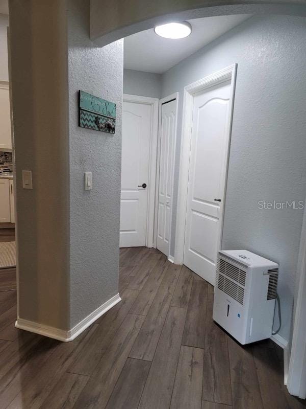 hallway with dark wood-type flooring