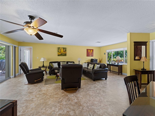 living room featuring a textured ceiling and ceiling fan