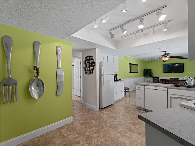 kitchen featuring white cabinets, white appliances, a textured ceiling, ceiling fan, and sink