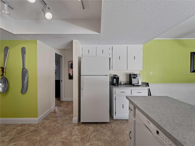 424 Baycrest Dr, Venice, FL 34285 - kitchen featuring white appliances, white cabinetry, a textured ceiling, wood walls, and light countertops