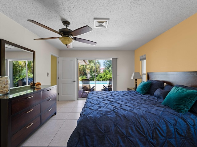 bedroom featuring multiple windows, a textured ceiling, ceiling fan, and access to exterior