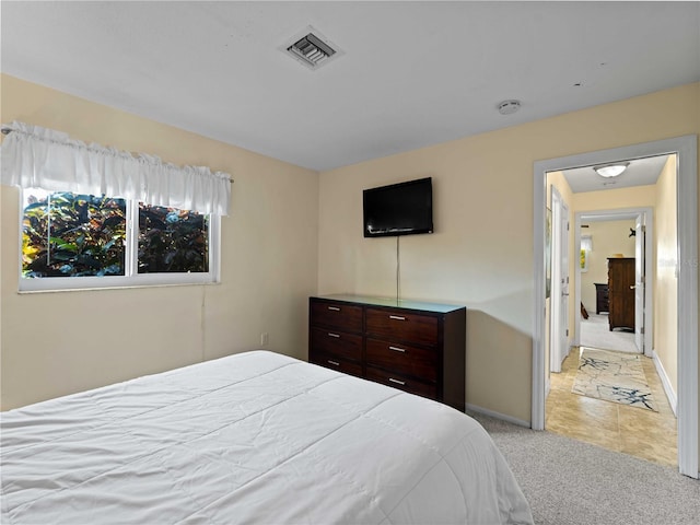 bedroom featuring light colored carpet