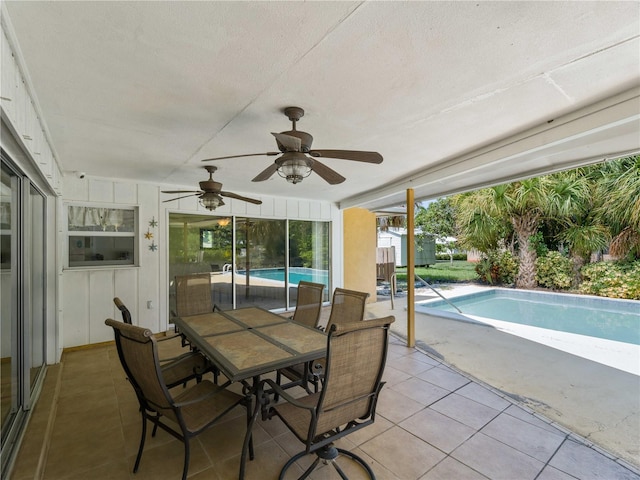 sunroom with a pool and ceiling fan