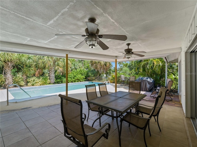 sunroom with a pool and ceiling fan