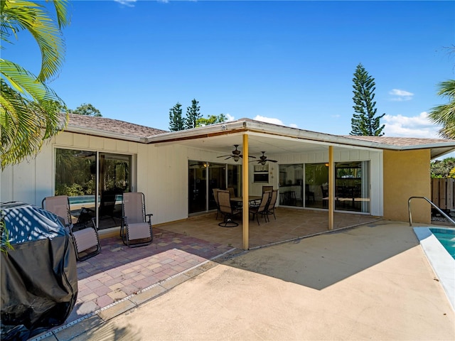 rear view of house featuring ceiling fan and a patio area