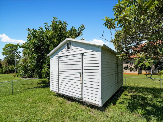 view of outbuilding featuring a lawn