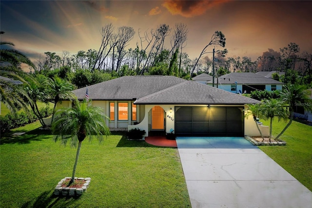 view of front of home featuring a yard and a garage