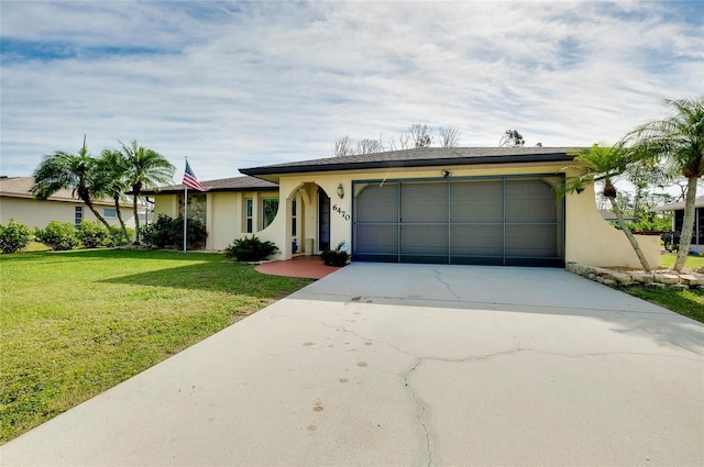 ranch-style home featuring a front yard and a garage