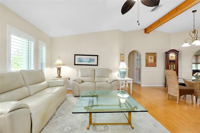 living room with vaulted ceiling with beams, light wood-type flooring, and ceiling fan with notable chandelier