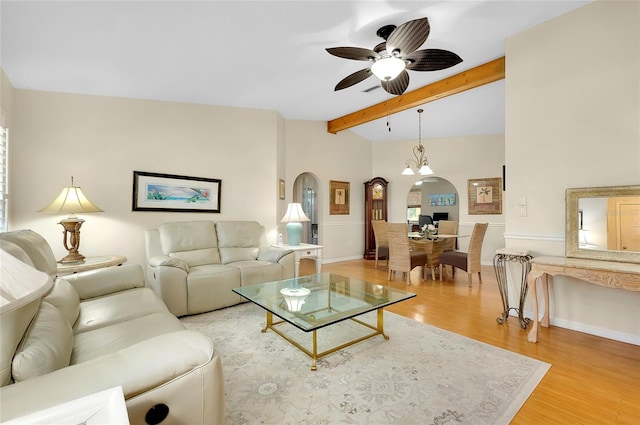 living room featuring vaulted ceiling with beams, light hardwood / wood-style flooring, and ceiling fan