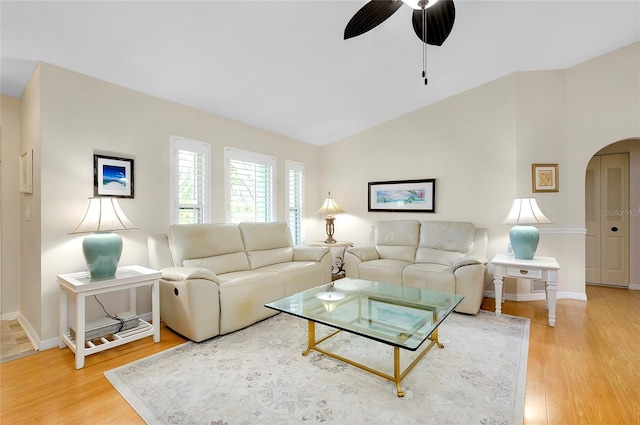 living room featuring ceiling fan, wood-type flooring, and vaulted ceiling