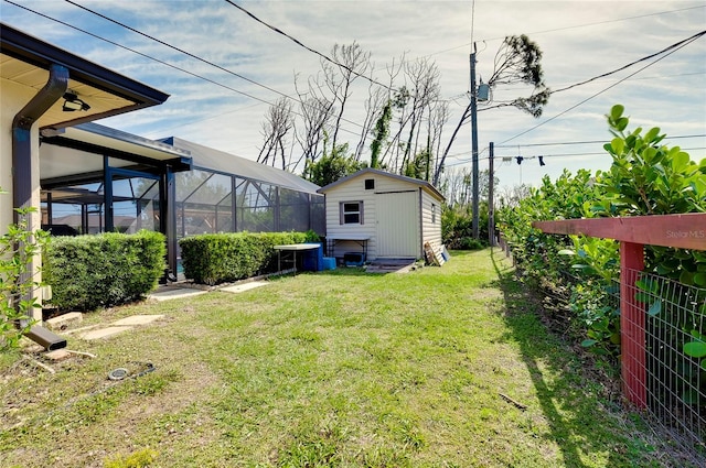 view of yard featuring a storage shed and glass enclosure