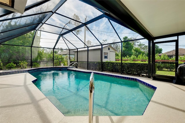 view of swimming pool with a shed, a patio area, and glass enclosure