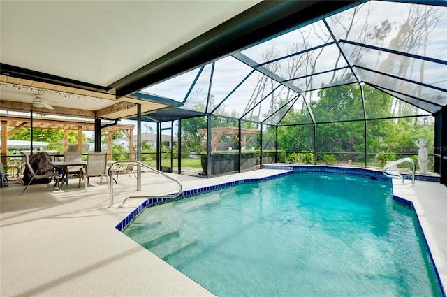 view of swimming pool featuring a patio area, ceiling fan, and glass enclosure