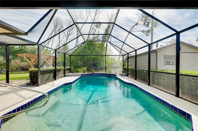 view of swimming pool featuring glass enclosure