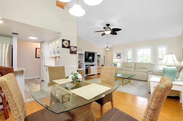 dining area with vaulted ceiling, light hardwood / wood-style floors, and ceiling fan