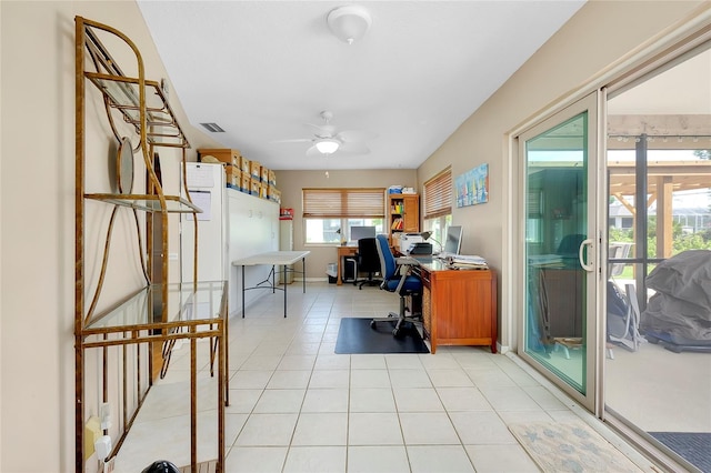 tiled office space featuring ceiling fan